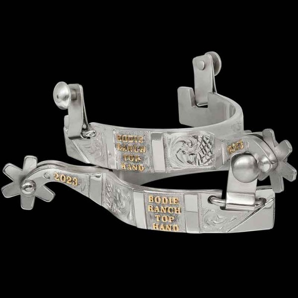 Feel like Jesse James when you ride with this beautifully crafted set of spurs. They are built with high quality German Silver and hand engraved on the entire outside as well as each side of the shanks. Detailed with Jewelers Bronze lettering.

 Size: 1